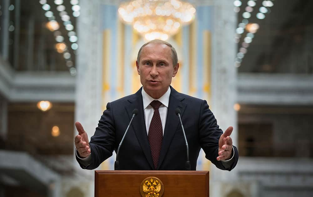 Russian President Vladimir Putin gestures as he speaks to the media after his talks with Ukrainian President Petro Poroshenko in Minsk, Belarus