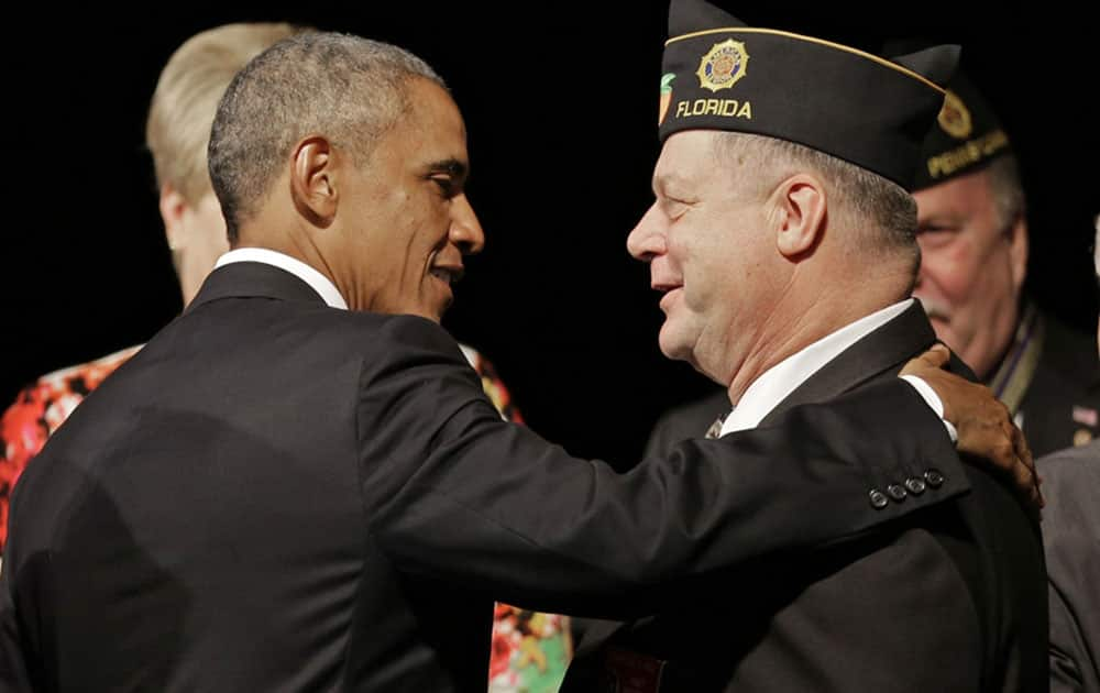 President Barack Obama greets a legionnaire after speaking at the American Legion national convention in Charlotte, N.C.