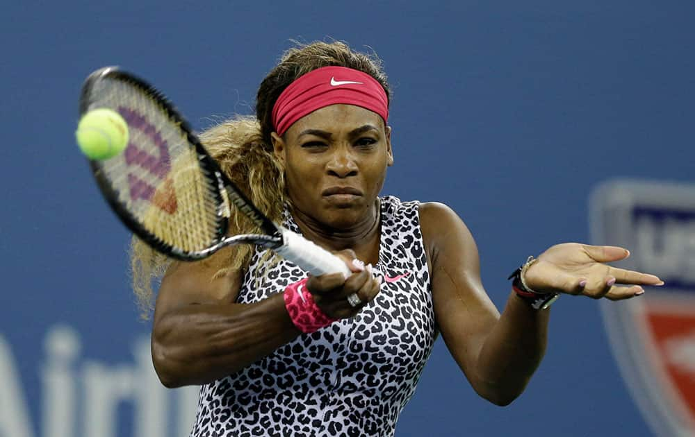 Serena Williams, of the United States, returns a shot to Taylor Townsend, of the United States, during the first round of the 2014 U.S. Open tennis tournament.