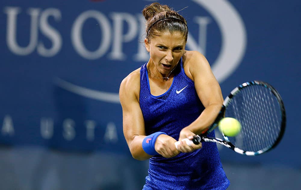 Sara Errani, of Italy, returns a shot to Kirsten Flipkens, of Belgium, during the opening round of the US Open tennis tournament, in New York.