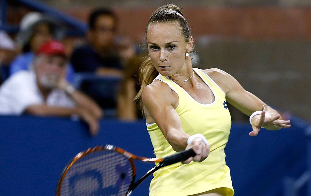 Magdalena Rybarikova, of Slovakia, returns a shot to Caroline Wozniacki, of Denmark, during the opening round of the US Open tennis tournament, in New York.