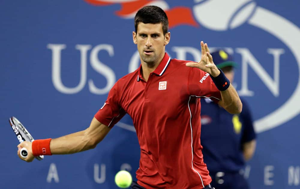 Novak Djokovic, of Serbia, returns a shot to Diego Schwartzman, of Argentina, during the opening round of the US Open tennis tournament, in New York.