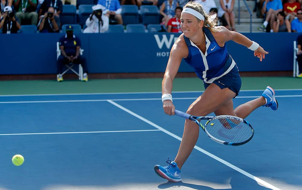 Victoria Azarenka, of Belarus, chases down a shot against Misaki Doi, of Japan, during the first round of the 2014 US Open tennis tournament, in New York.