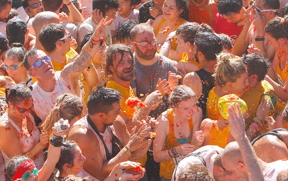 Crowds of people throw tomatoes at each other, during the annual 'tomatina' tomato fight fiesta, in the village of Bunol, 50 kilometers outside Valencia, Spain.