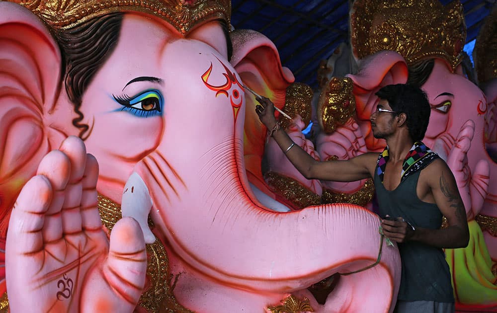 An Indian artist paints an idol of elephant-headed Hindu god Ganesha ahead of Ganesha Chaturthi festival in Hyderabad.