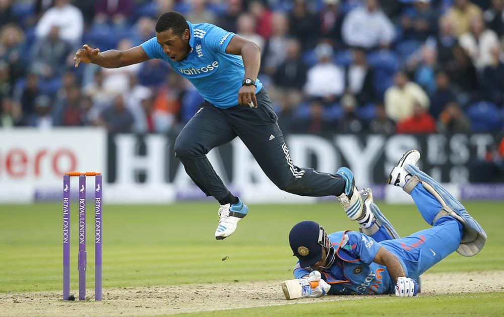 England's bowler Chris Jordan collides with India's MS Dhoni, during an attempted run out, in their One Day International cricket match at the SWALEC cricket ground in Cardiff, Wales.