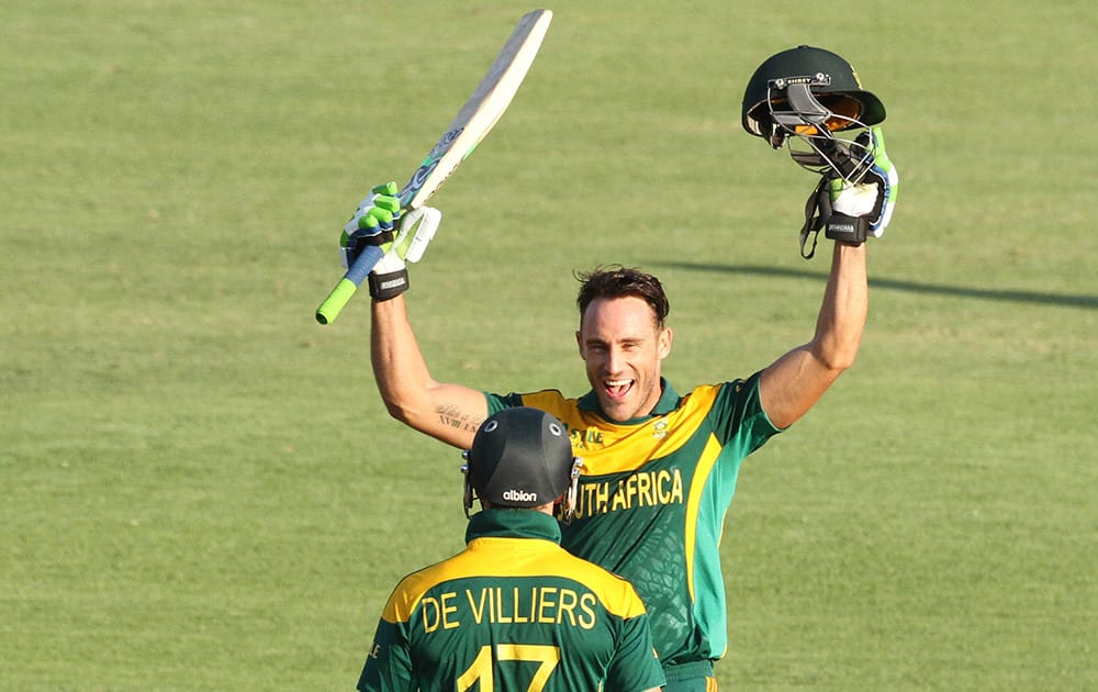 South African player Faf du Plessis, celebrates with AB de Villiers after scoring 100 runs during the cricket One Day International match against Australia in Harare Zimbabwe.