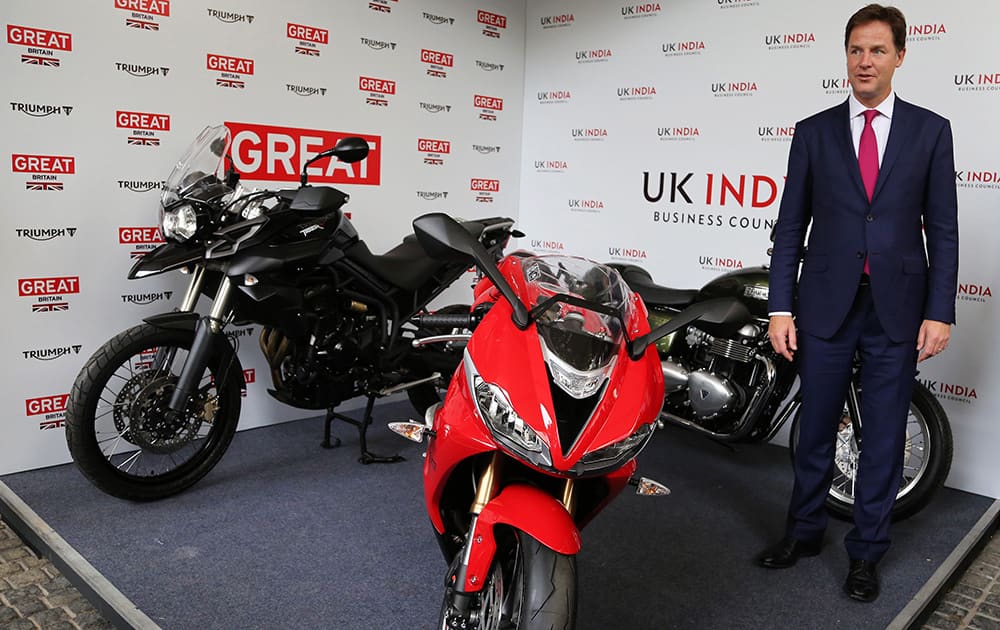 Britain's Deputy Prime Minister Nick Clegg poses with Triumph motorcycles during the inauguration of the United Kingdom India Business Council Centre in Bangalore.