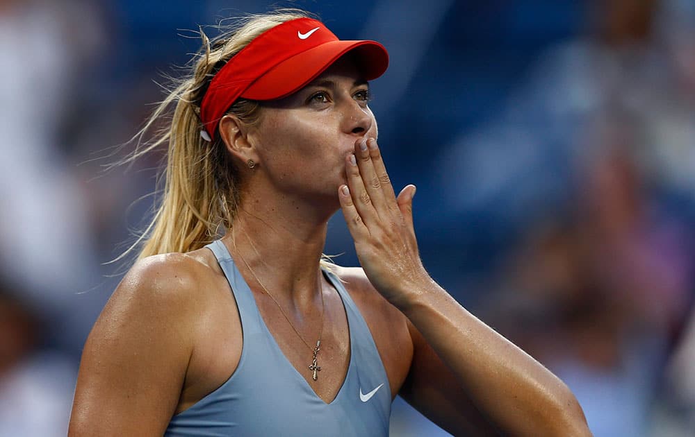 Maria Sharapova, of Russia, blows kisses to the crowd after defeating Alexandra Dulgheru, of Romania, during the second round of the 2014 US Open tennis tournament.