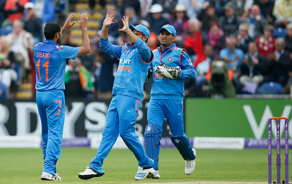 Mohammed Shami, left, celebrates taking the wicket of England's Alastair Cook, lbw, during their One Day International cricket match at the SWALEC cricket ground in Cardiff, Wales.