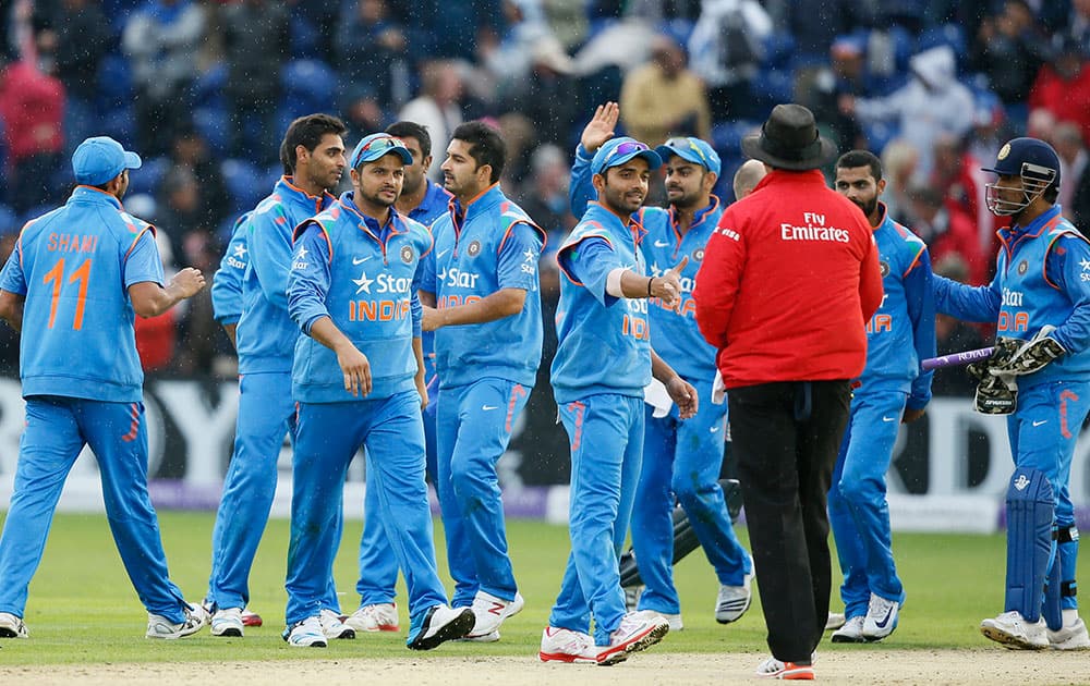 India's Suresh Raina, third left, celebrates with his teammates after they defeated England in their One Day International cricket match at the SWALEC cricket ground in Cardiff, Wales, 