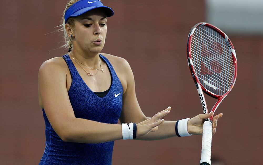 Sabine Lisicki, of Germany, reacts after missing a shot against Madison Brengle, of the United States, during the second round of the 2014 U.S. Open tennis tournament in New York.