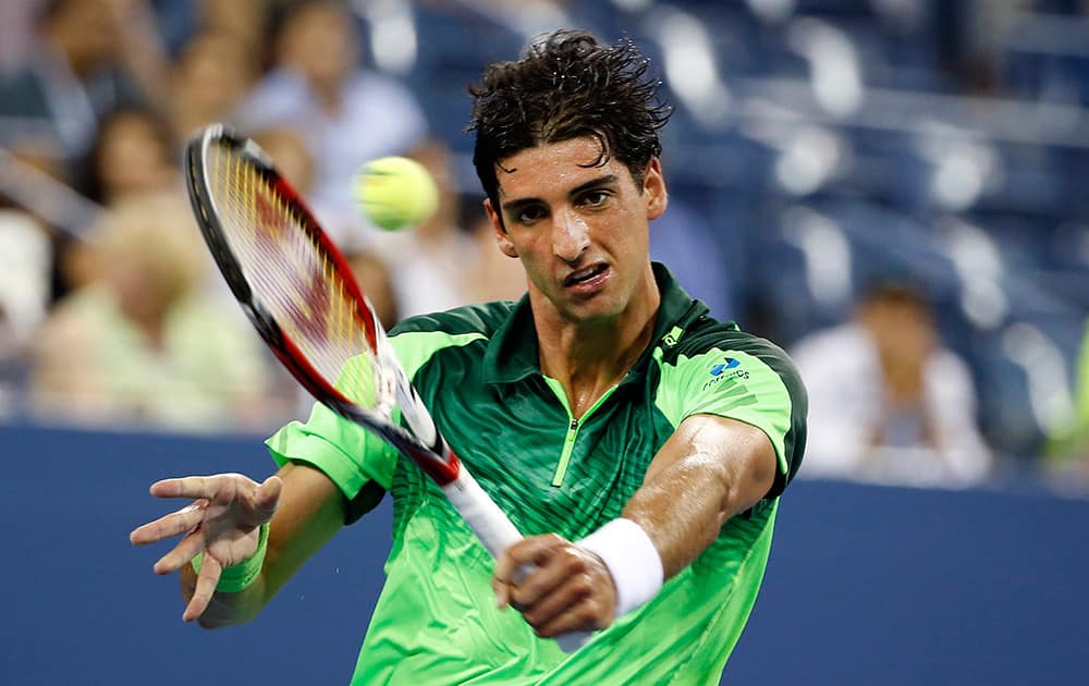 Thomaz Bellucci, of Brazil, returns a shot to Stan Wawrinka, of Switzerland, during the second round of the U.S. Open tennis tournament in New York.