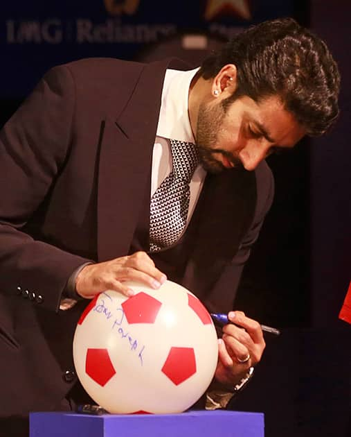 Abhishek Bachchan, Bollywood actor and co-owner of Team Chennai, signs a soccer ball during the official launch of the Indian Super League (ISL) in Mumbai.