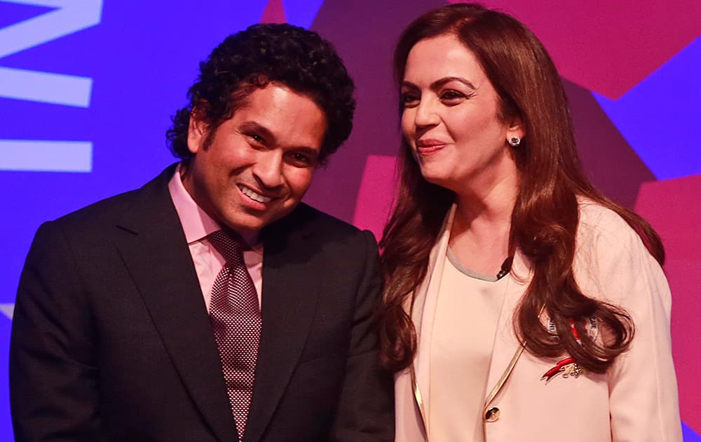 Sachin Tendulkar, former Indian cricketer and co-owner of Kerala Blasters Football Club, listens to Reliance Foundation Chairman Nita Ambani during the official launch of the Indian Super League (ISL) in Mumbai.