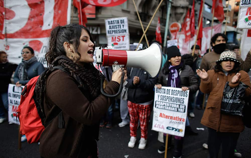 Protesters shout slogans as they block an avenue during a strike in Buenos Aires, Argentina.