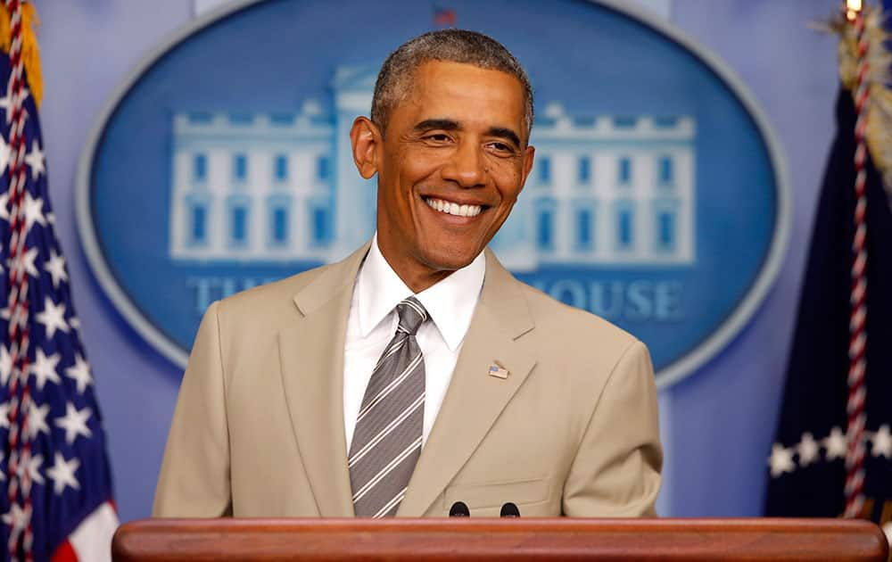 President Barack Obama smiles as he takes questions about the economy, Iraq, and Ukraine.