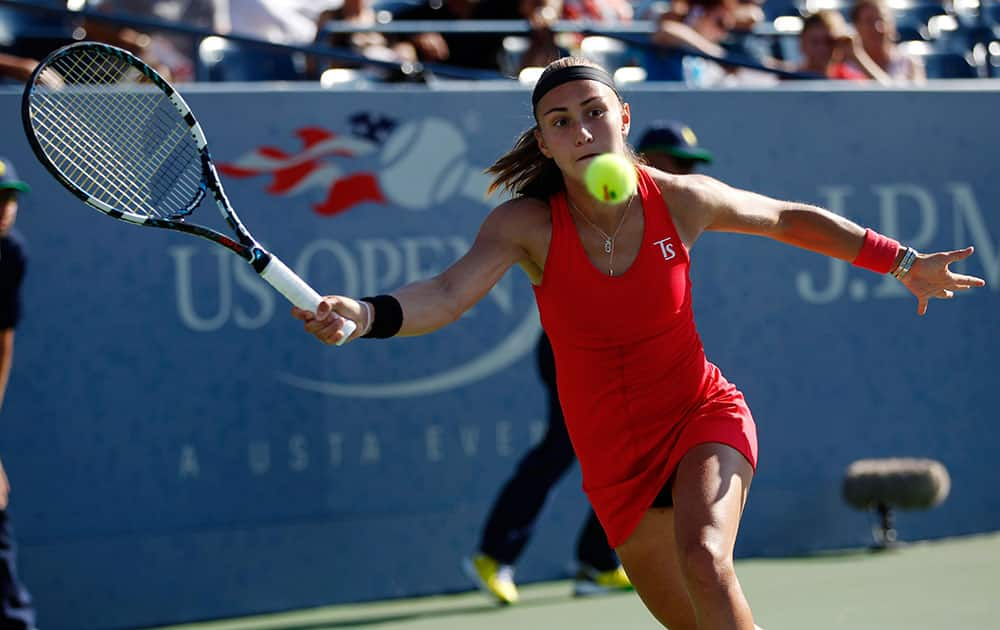 Aleksandra Krunic, of Serbia, returns a shot to Madison Keys, of the United States, during the second round of the 2014 US Open tennis tournament in New York.