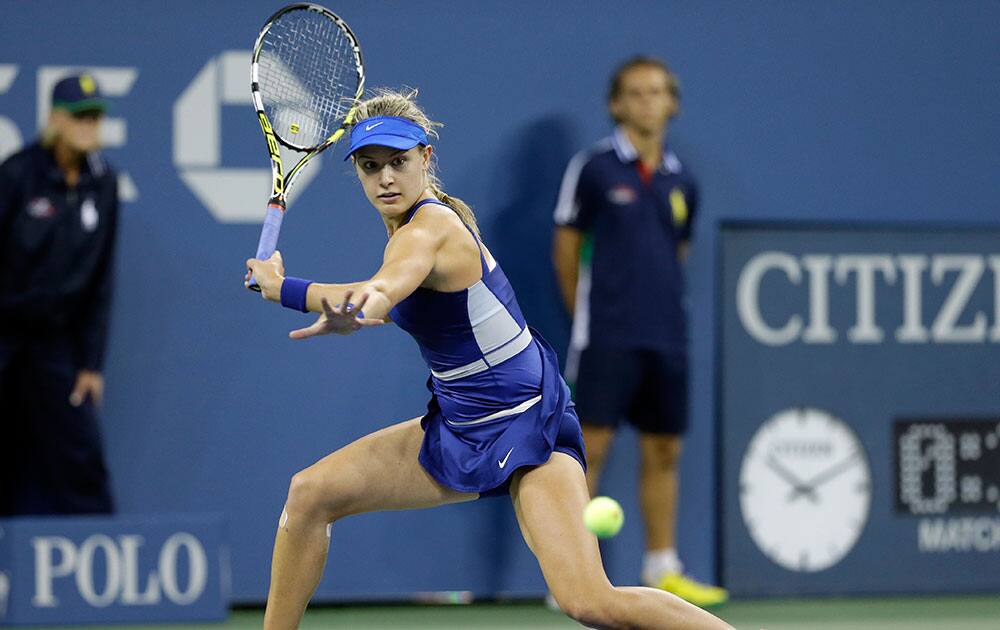 Eugenie Bouchard, of Canada, returns a shot to Sorana Cirstea, of Romania, during the second round of the 2014 US Open tennis tournament in New York.