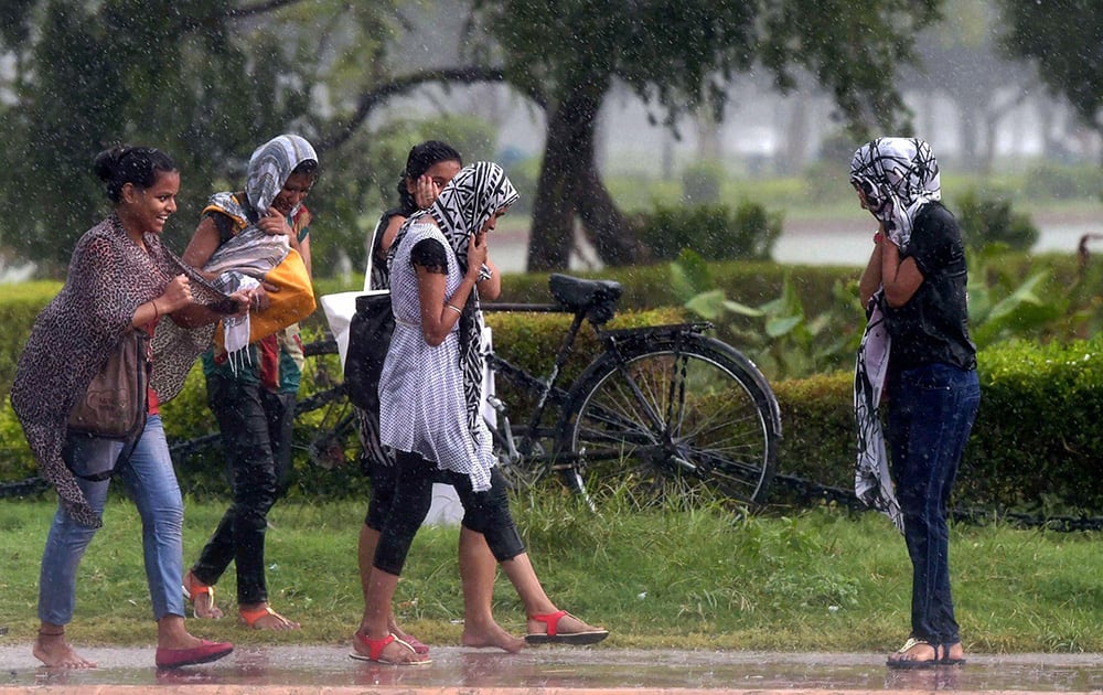 Girls enjoying dip in temperature at Rajpath after rains lashed New Delhi.