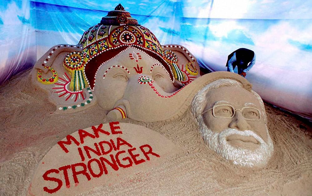 A sand sculpture created by sand artist Sudarsan Pattnaik depicting Lord Ganesh blessing Prime Minister Narendra Modi in Surat.