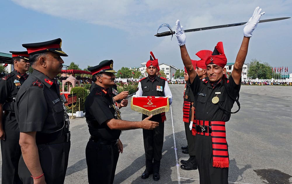 Lieutenant General RN Nair presents the Sher-e-Kashmir, Sword of Honour to Bachan Singh for his performance in all disciplines during his training at the passing out parade at Jammu and Kashmir Light Infantry Regimental Centre, in Srinagar.