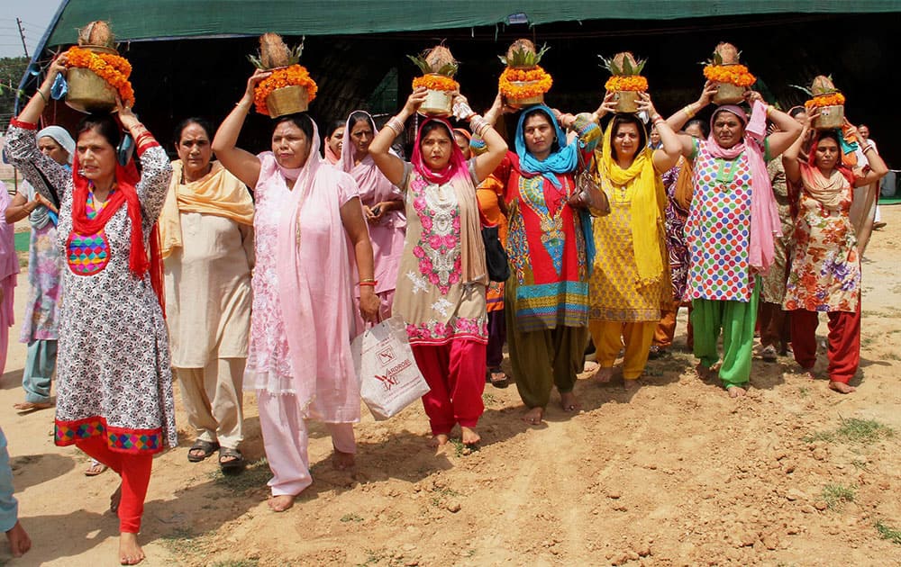 Devotees taking part in a 'Kalash Yatra' on the occasion of Ganesh Chaturthi in Jammu.