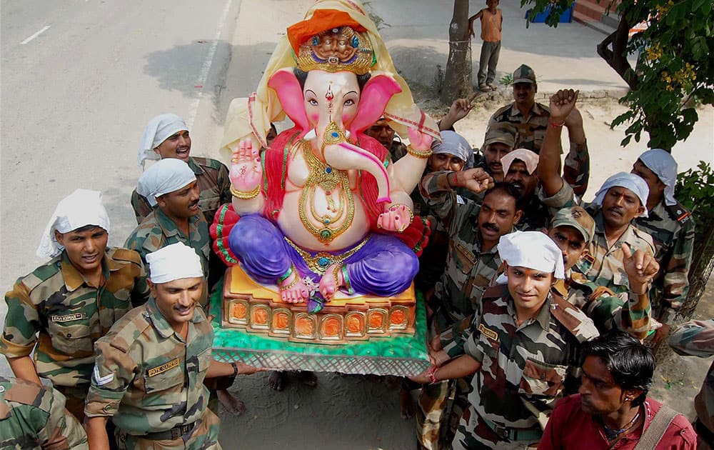 Army soldiers carrying the idol of Lord Ganesha to a camp on the occasion of of Ganesh Chaturthi in Patiala.