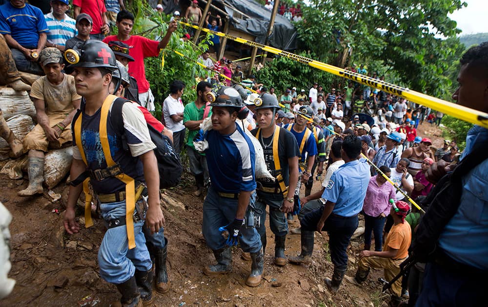 Miners walk in line as they enter the El Comal mine to help in the rescue operations at the gold and silver mine after a landslide trapped at least 24 miners inside, in Bonanza, Nicaragua.