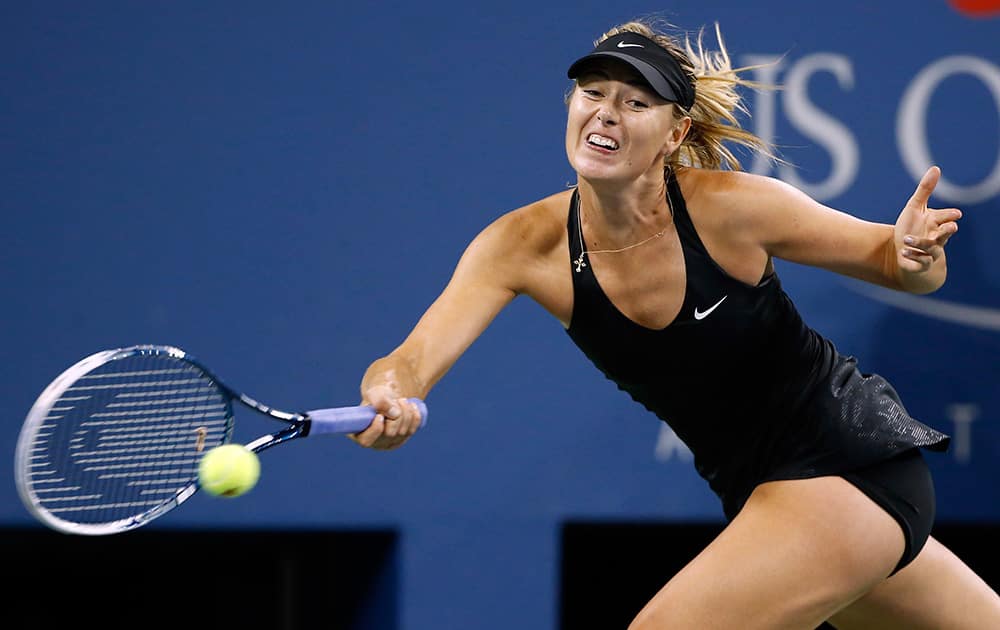 Maria Sharapova, of Russia, returns a shot to Sabine Lisicki, of Germany, during the third round of the U.S. Open tennis tournament in New York. Sharapova won 6-2, 6-4. 