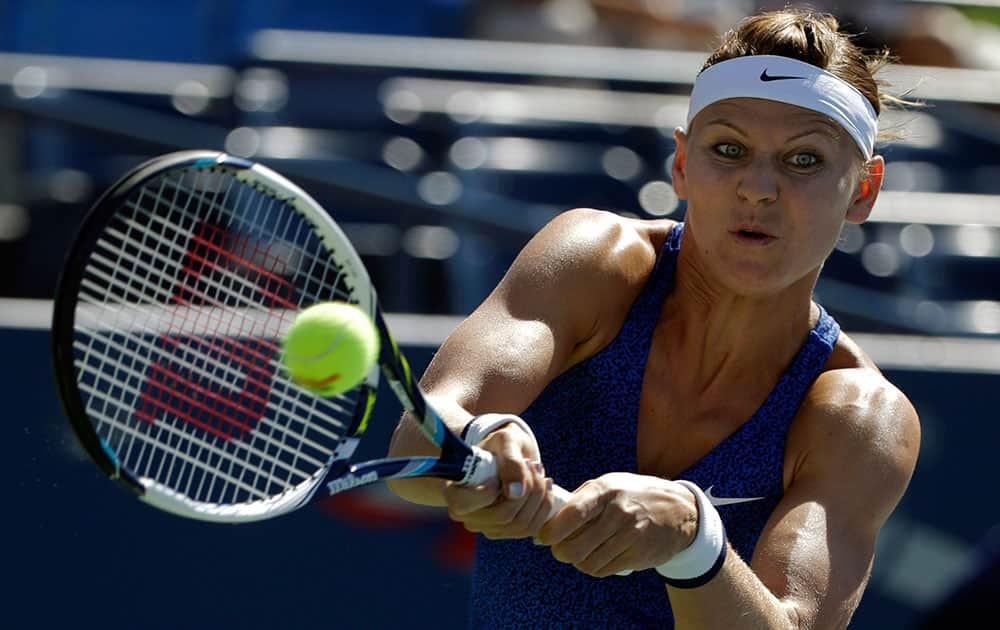 Lucie Safarova, of the Czech Republic, returns a shot to Alize Cornet, of France, during the third round of the 2014 US Open tennis tournament.