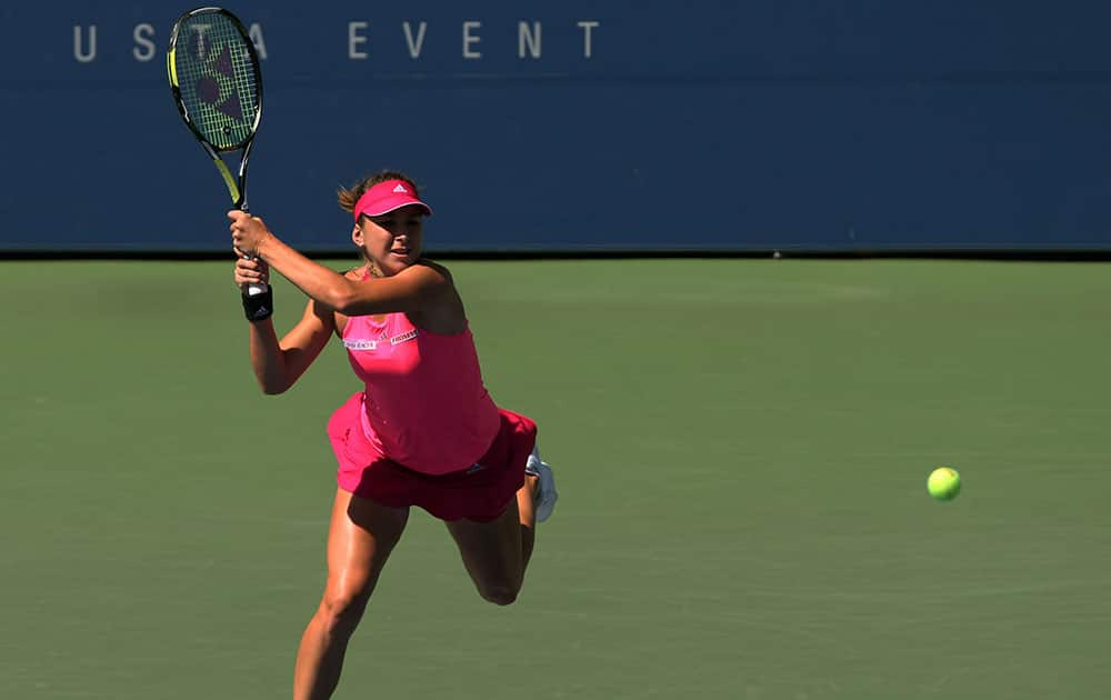 Belinda Bencic, of Switzerland, returns a shot to Angelique Kerber, of Germany, during the third round of the 2014 US Open tennis tournament.