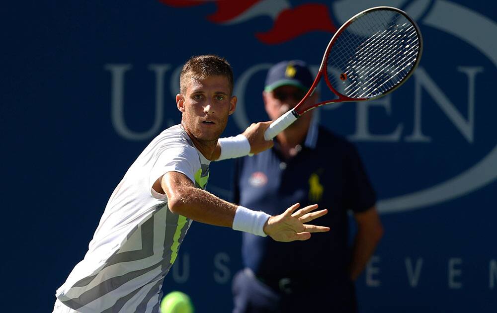 Martin Klizan, of Slovakia, returns a shot against Tomas Berdych, of the Czech Republic, during the second round of the 2014 US Open tennis tournament.