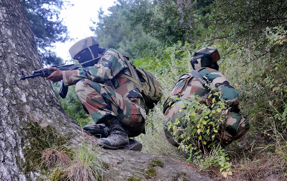 Army personnel taking position during an encounter with the militants at Baron Gali in Kalaro near the Line of Control (LOC) in Kupwara.