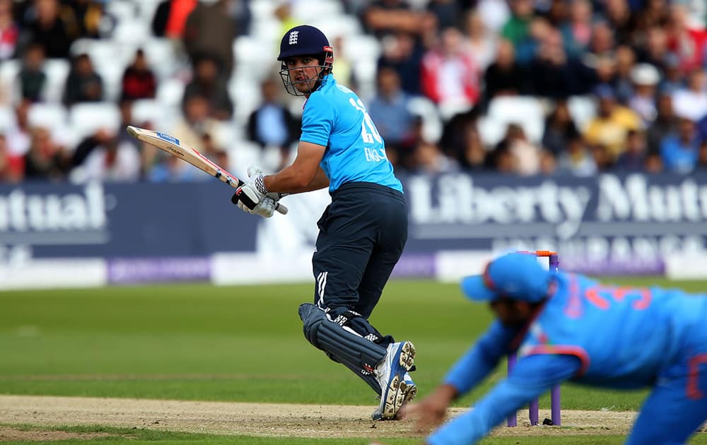 England's Alastair Cook, left, is almost caught in the slips during their One Day International cricket match against India at the Trent Bridge cricket ground in Nottingham, England.