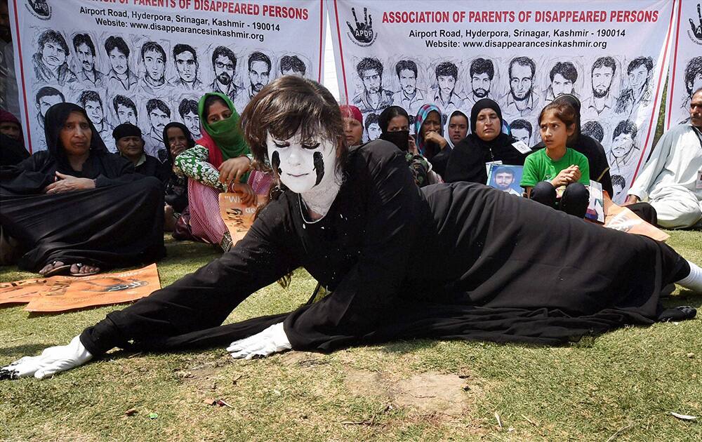 An artist performs during a play at a park in Srinagar on the occasion of International Day of the Disappeared.