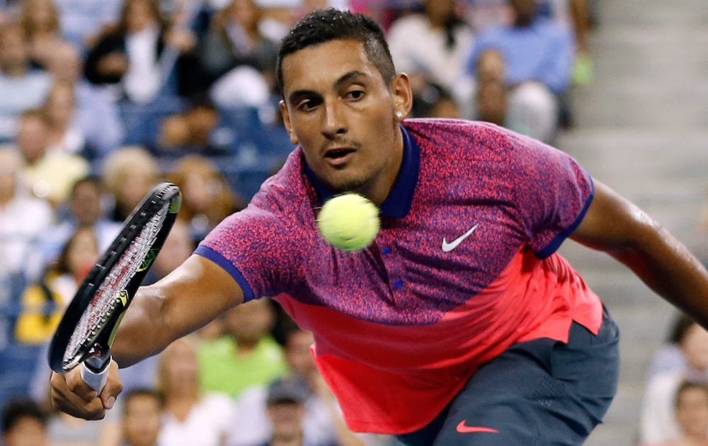 Nick Kyrgios, of Australia, reaches for a volley against Tommy Robredo, of Spain, during the third round of the U.S. Open tennis tournament.