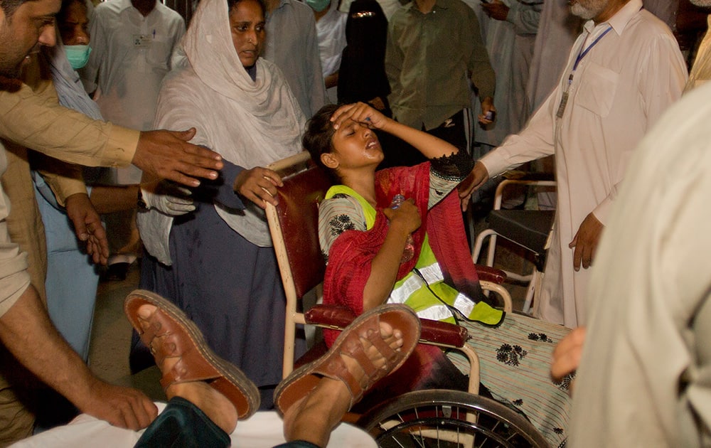 People rush injured protesters to a local hospital n Islamabad, Pakistan. 