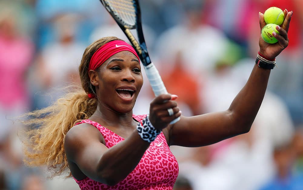 Serena Williams, of the United States, reacts to the crowd as she prepares to hit balls into the stands after defeating Varvara Lepchenko, of the United States, during the third round of the 2014 US Open tennis tournament.