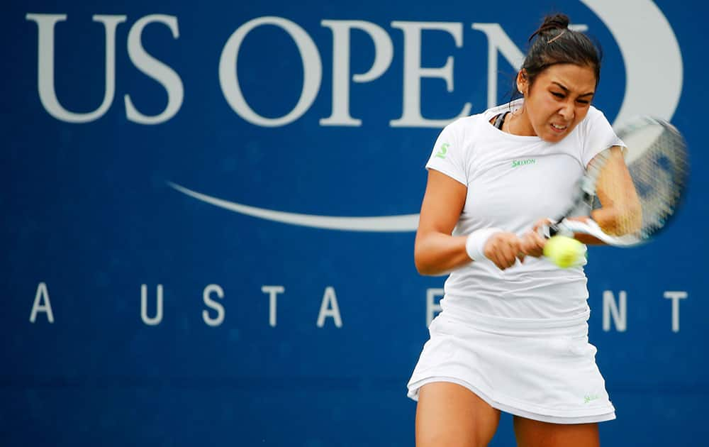 Zarina Diyas, of Kazakhstan, returns a shot against Ekaterina Makarova, of Russia, during the third round of the 2014 US Open tennis tournament.