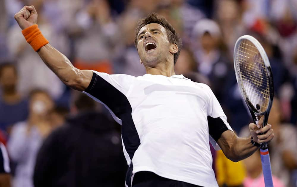 Tommy Robredo, of Spain, reacts after defeating Nick Kyrgios, of Australia, in the third round of the US Open tennis tournament.