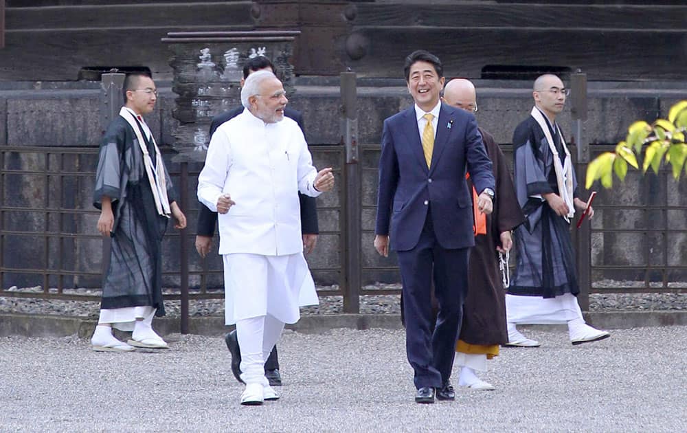 Indian Prime Minister Narendra Modi, front left, and his Japanese counterpart Shinzo Abe, front right, stroll at Toji Temple in Kyoto, western Japan.