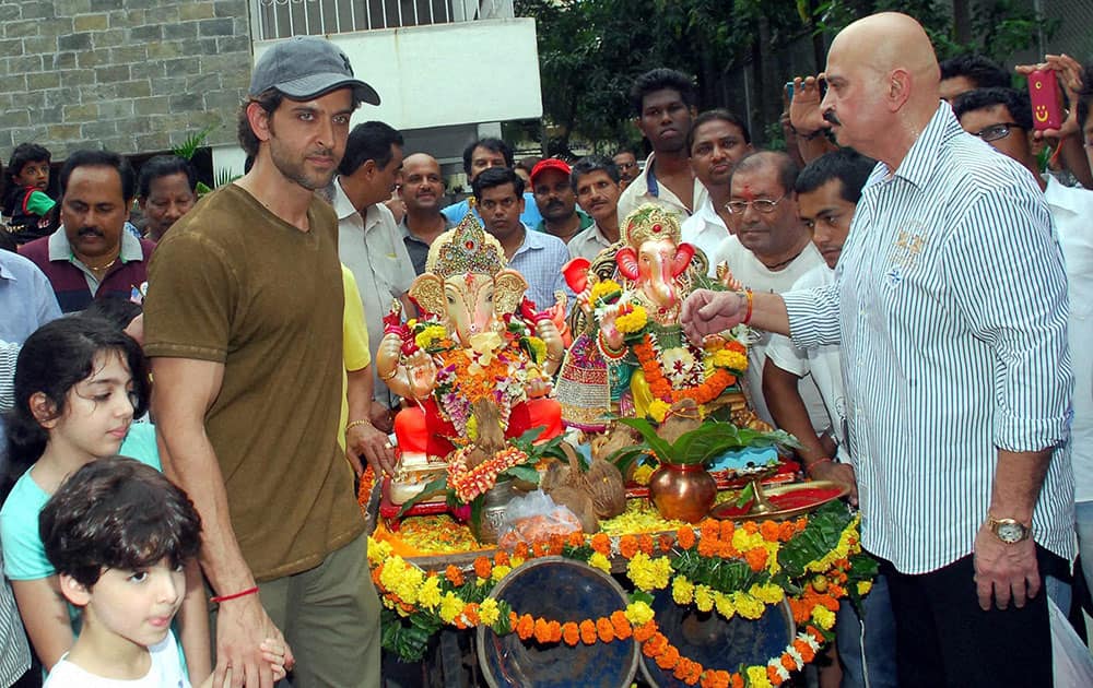 Bollywood actor Hrithik Roshan with father Rakesh Roshan and others participates in a procession for the immersion of an idol of the elephant-headed Hindu god Lord Ganesha in Mumbai.