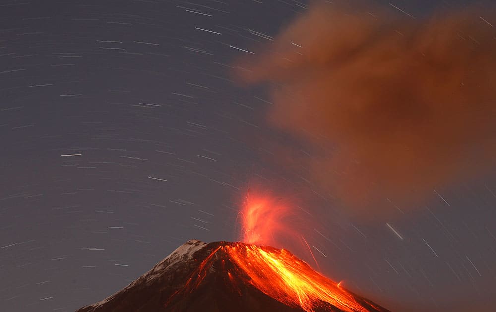 The Tungurahua volcano throws ash and stones during an eruption seen from Banos, Ecuador