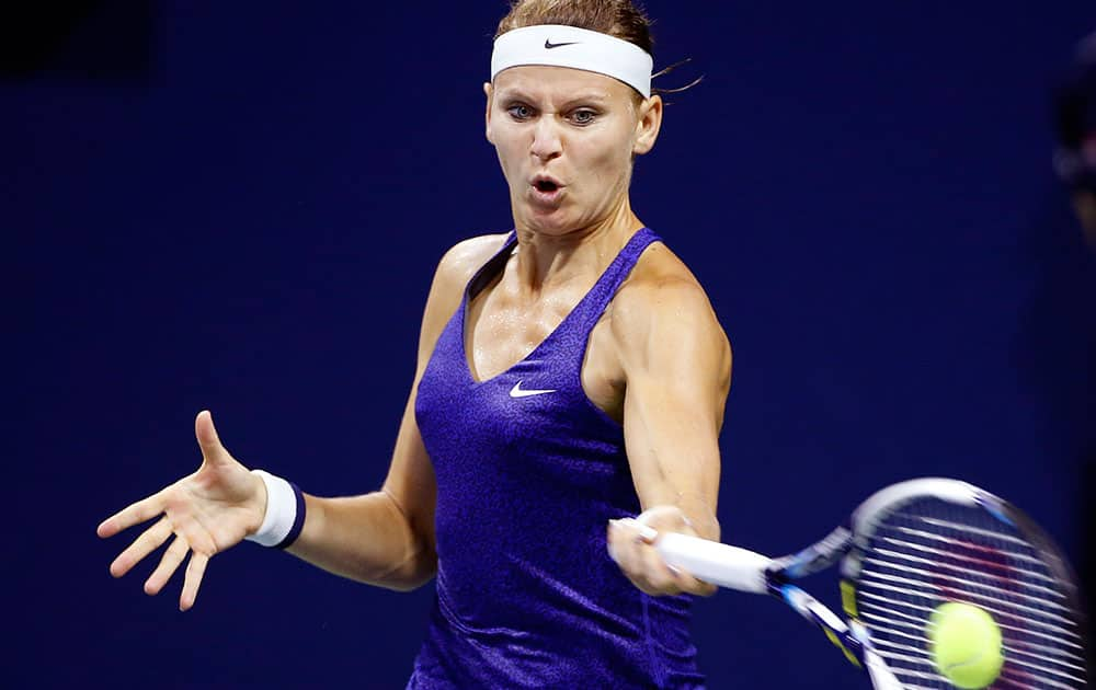 Lucie Safarova, of Czech Republic, returns a shot to Shuai Peng, of China, during the fourth round of the US Open tennis tournament.