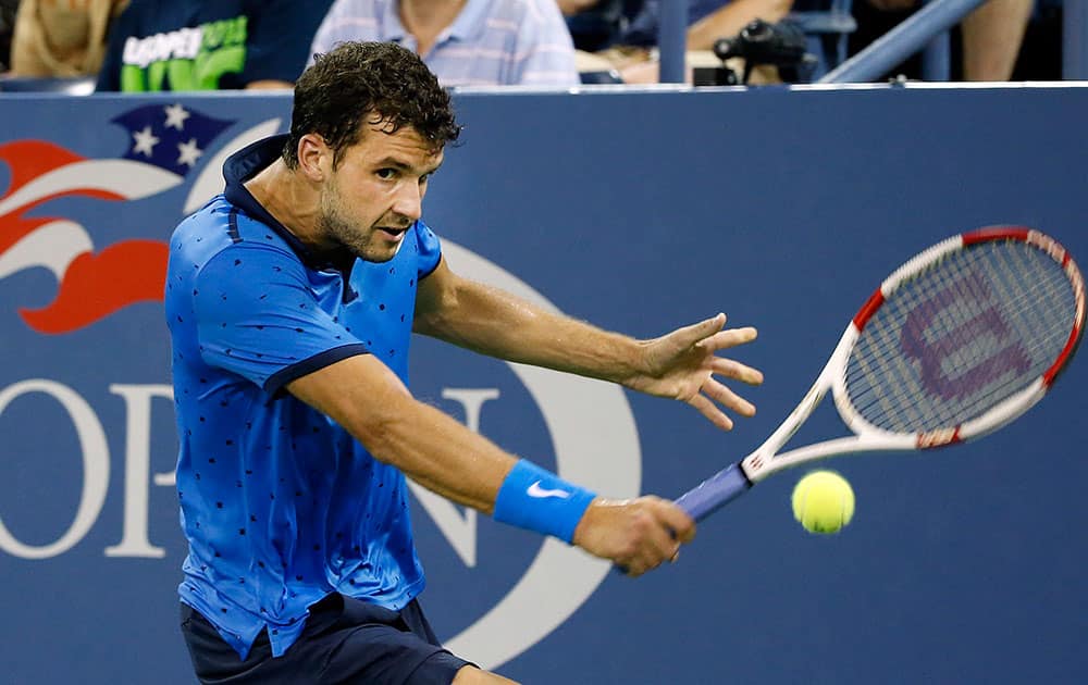 Grigor Dimitrov, of Bulgaria, returns a shot to David Goffin, of Belgium, during the third round of the US Open tennis tournament.