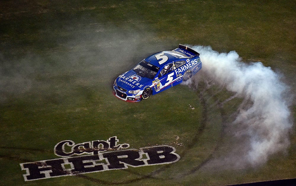 Sprint Cup Series driver Kasey Kahne does a burnout after winning a NASCAR Sprint Cup auto race at Atlanta Motor Speedway,  in Hampton, Ga. 