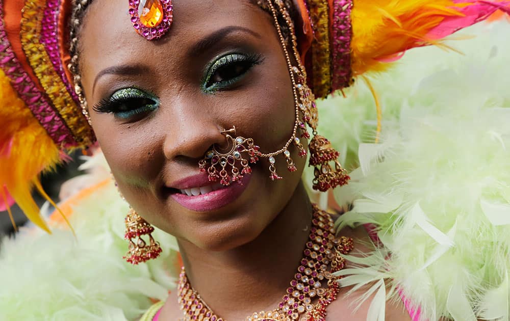 A dancer poses for a photograph during the West Indian Day Parade, Monday, Sept. 1, 2014 in the Brooklyn borough of New York. 