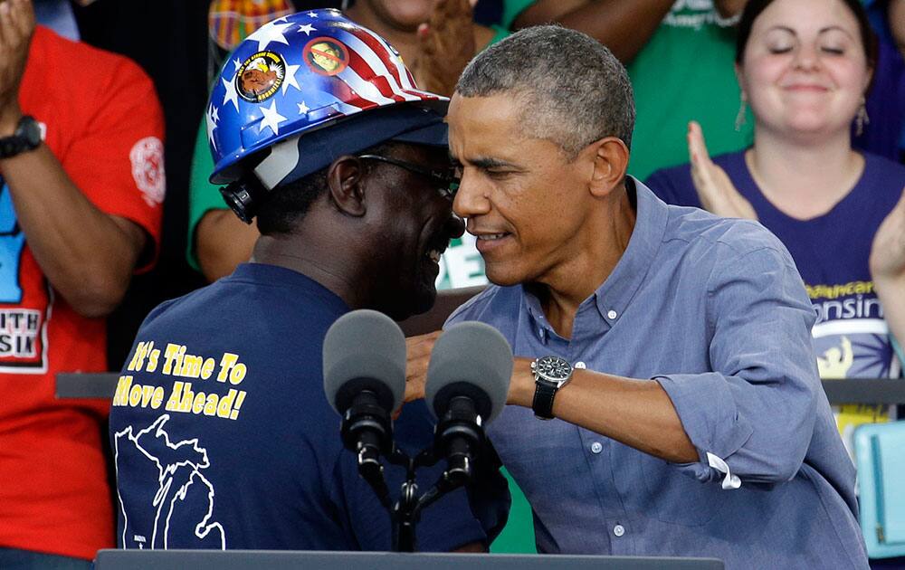 President Obama hugs Chris Harris, Vice President of United Steel Workers Local 2-209, after being introduced at Laborfest 2014 at Henry Maier Festival Park in Milwaukee. 