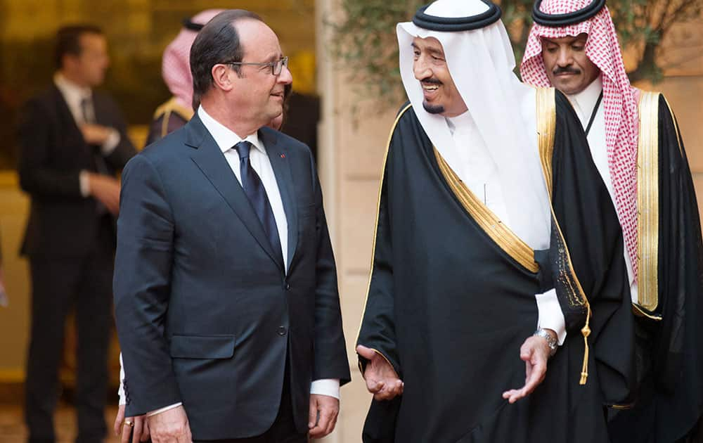 French President Francois Hollande, left, speaks with Defense Minister and Saudi Crown Prince Salman bin Abdul-Aziz prior to a dinner at the Elysee Palace in Paris.